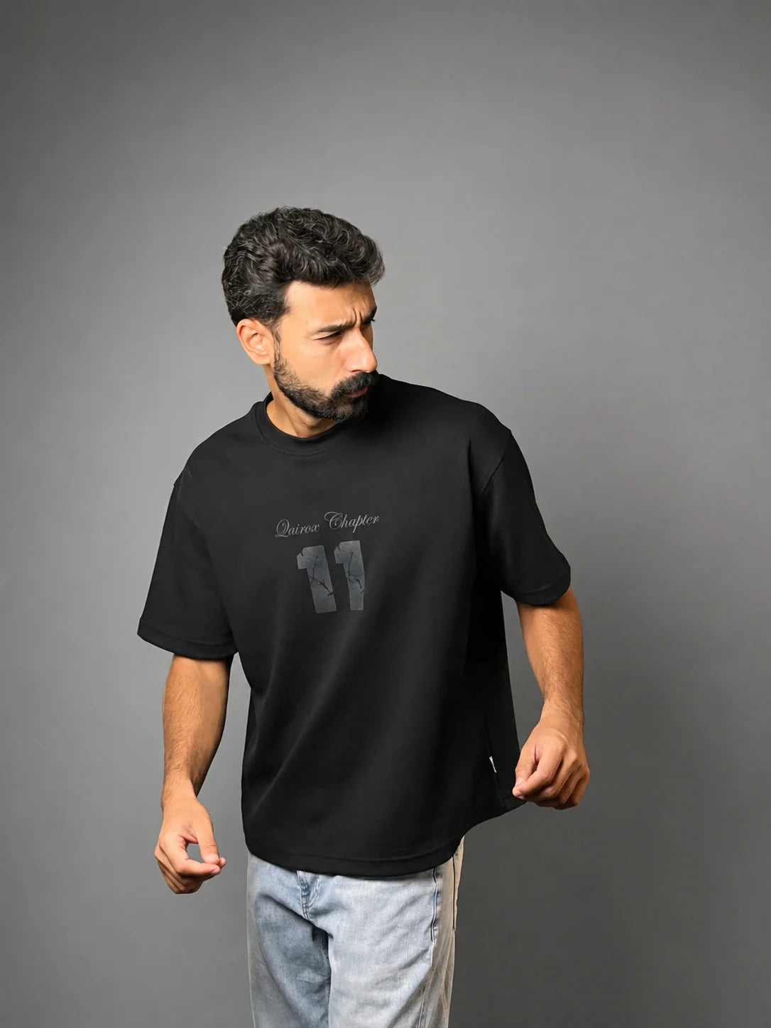 QAIROX Chapter Tee black front — Qairox Chapter tone-on-tone 11 graphic, relaxed boxy silhouette