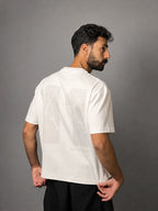 QAIROX Chapter Tee off-white back — oversized 11 cracked texture screen print, Built Different tagline, boxy fit