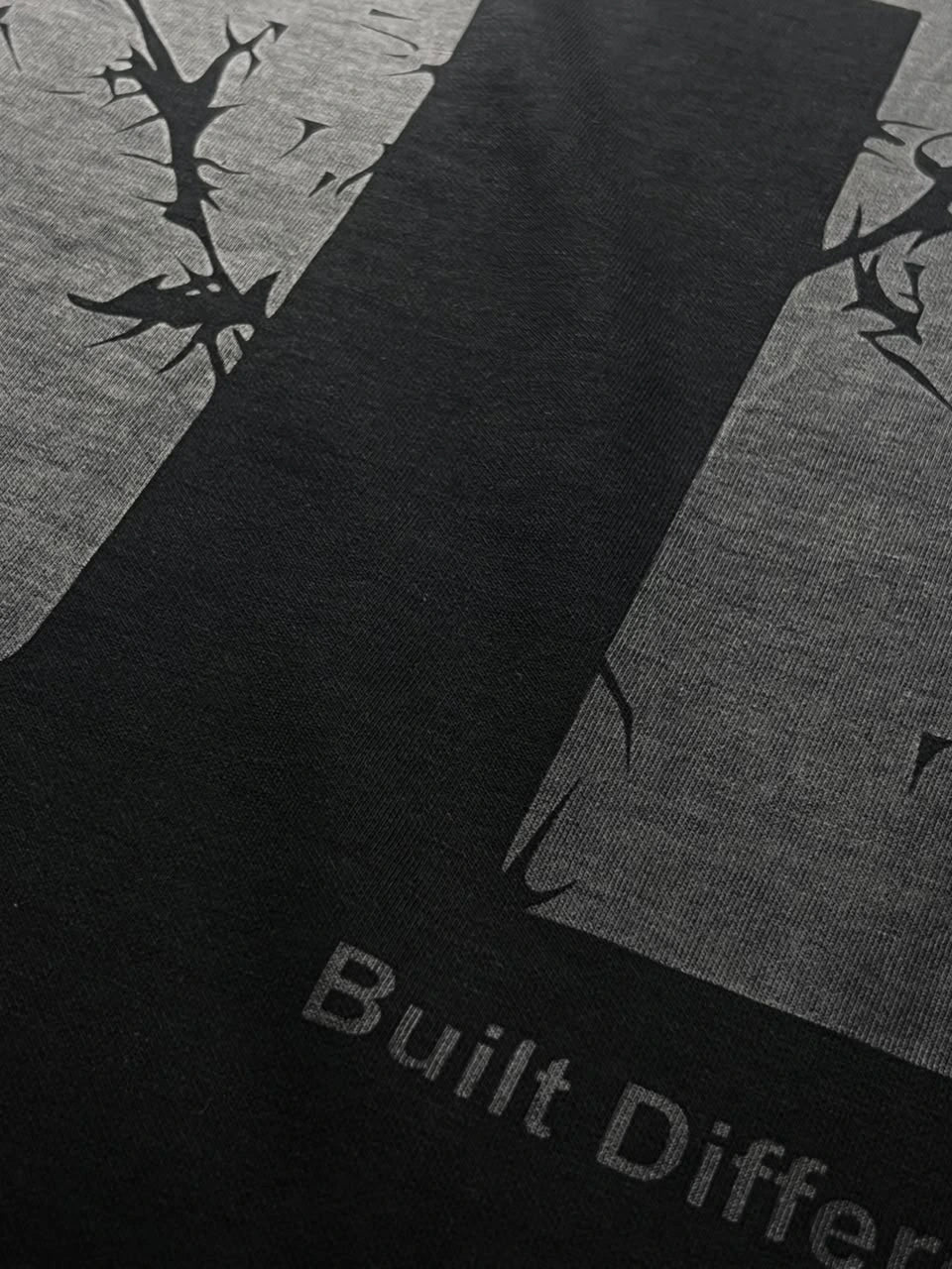 QAIROX Chapter Tee close-up — Qairox Chapter script with cracked texture 11 graphic, premium screen print detail on black cotton