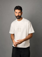 QAIROX Chapter Tee off-white front — Qairox Chapter tone-on-tone 11 graphic, relaxed boxy silhouette, 285 GSM cotton