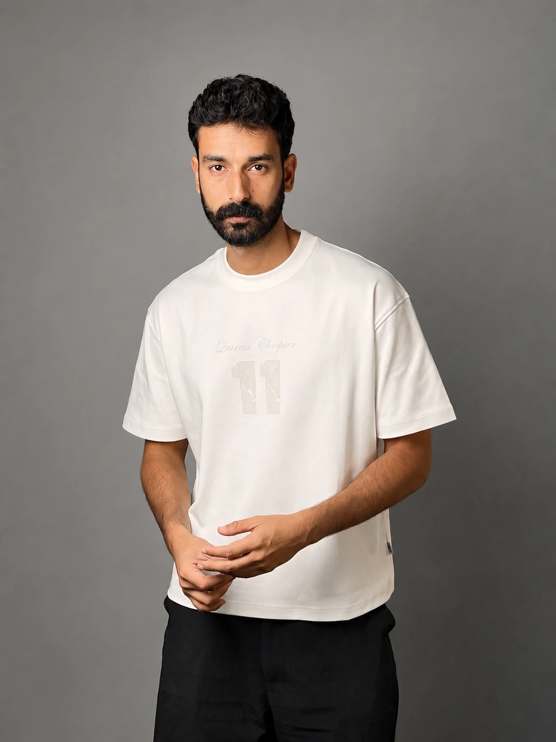 QAIROX Chapter Tee off-white front — Qairox Chapter tone-on-tone 11 graphic, relaxed boxy silhouette, 285 GSM cotton
