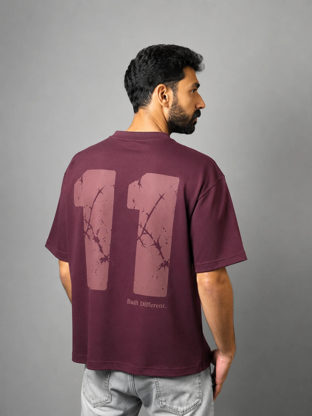 QAIROX Chapter Tee burgundy back — oversized 11 cracked texture screen print with Built Different tagline