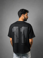 QAIROX Chapter Tee black back — oversized 11 graphic with thorn cracked texture screen print, Built Different tagline