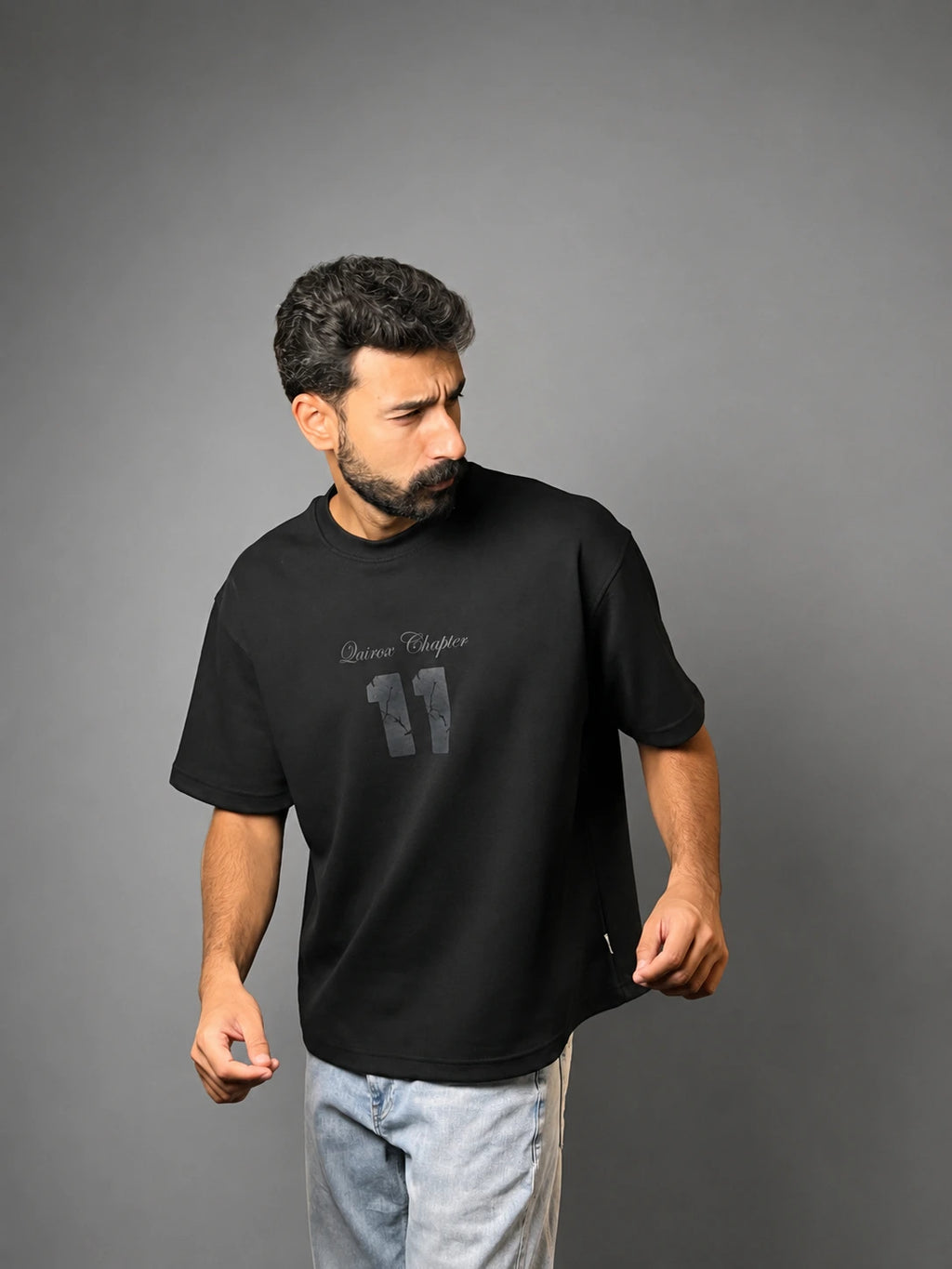 QAIROX Chapter Tee black front — Qairox Chapter tone-on-tone 11 graphic, relaxed boxy silhouette