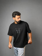 QAIROX Chapter Tee black front — Qairox Chapter tone-on-tone 11 graphic, relaxed boxy silhouette