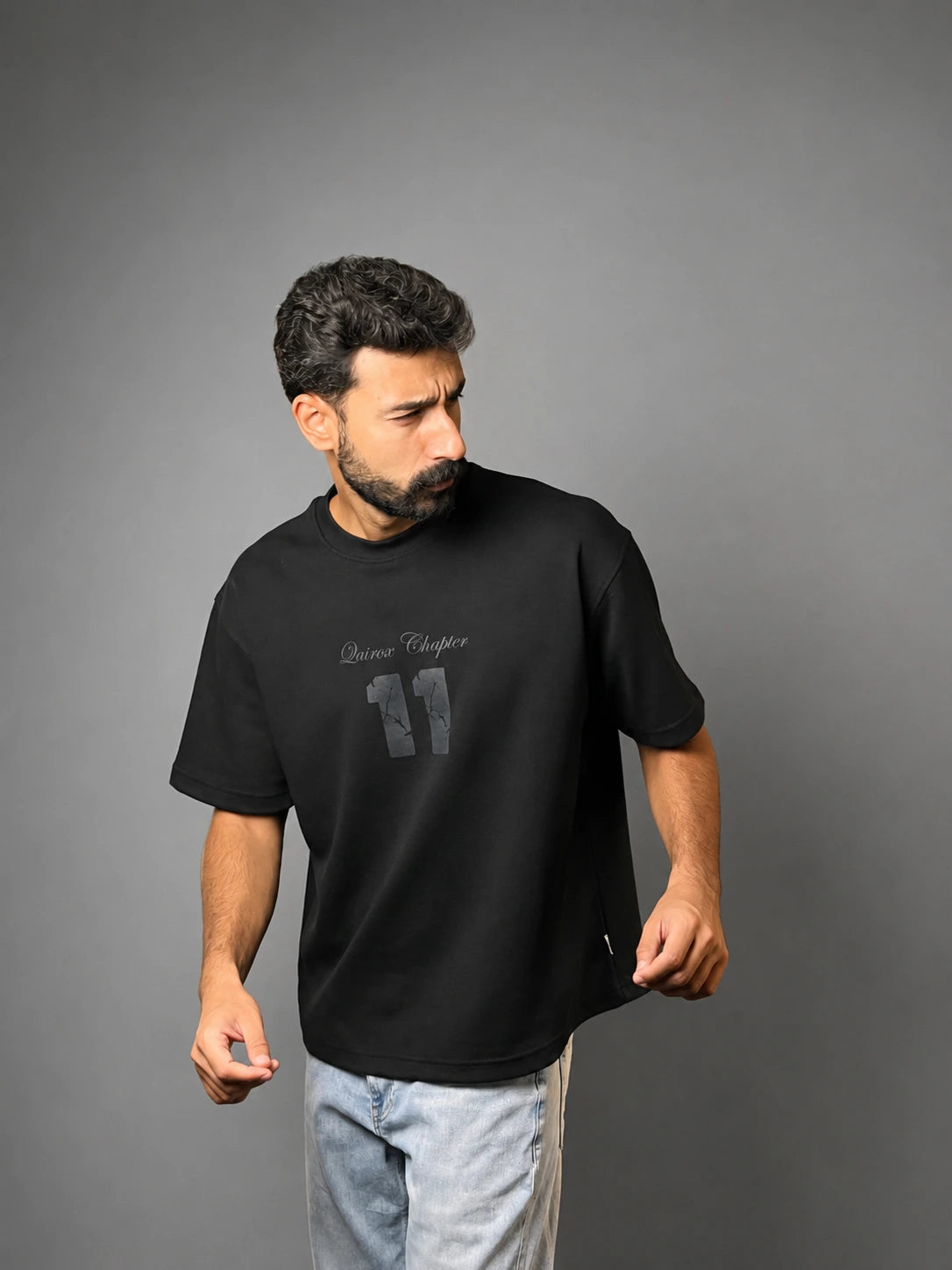 QAIROX Chapter Tee black front — Qairox Chapter tone-on-tone 11 graphic, relaxed boxy silhouette