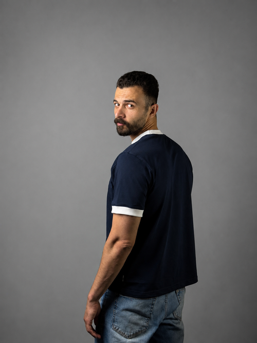 Man wearing QAIROX navy  ringer tee with white contrast collar and cuffs